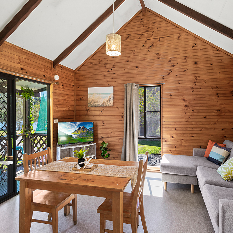 wooden panel living room inside cabin 1 the suite at mylestom cabins accommodation coffs harbour